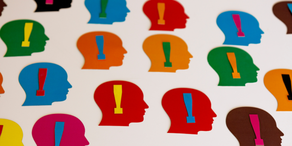 Various coloured head shapes with an exclamation mark inside each head shape