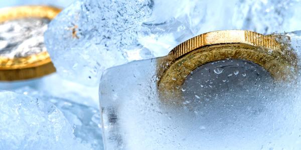 Pound coins frozen in ice
