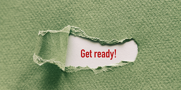 Green paper with a tear in the centre, through the tear white paper with the words 'GET READY!' can be seen in red text.