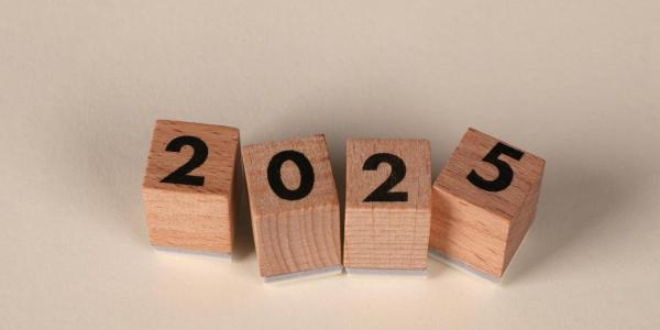 4 wooden blocks with a number on each, together they spell out "2025"