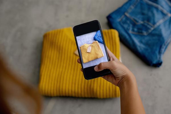 taking a picture with a mobile phone jumper with a price tag