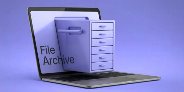 An open laptop with a filing cabinet protruding out from the screen with the words 'FILE ARCHIVE' 