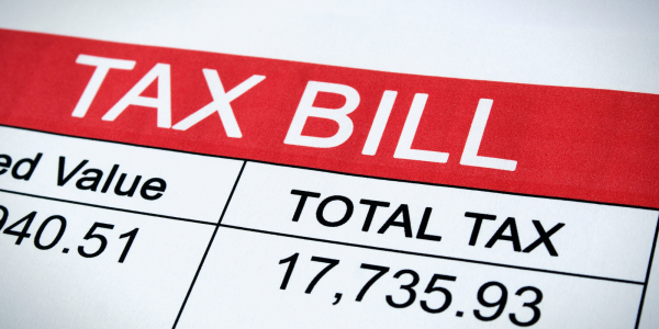 an example of a tax bill with the words 'TAX BILL' in large white text against a red background
