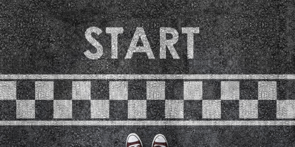 A white chequered patters painted onto tarmac with the word 'START' 