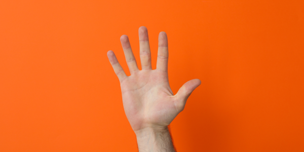 A hand holding up 5 fingers against an orange background