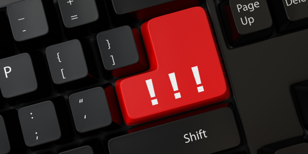 A black keyboard with 1 red button containing 3 exclamation marks 