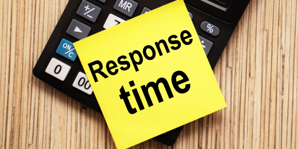 A calculator with a piece of yellow card on top, the card reads the words 'RESPONSE TIME' 