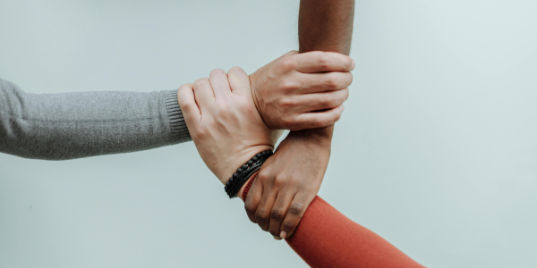 three hands supporting one another 