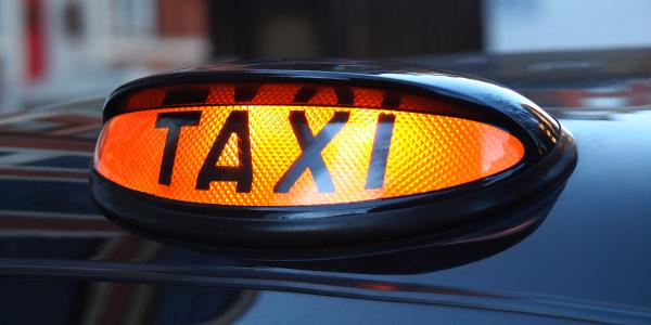 Image of a black cab taxi sign