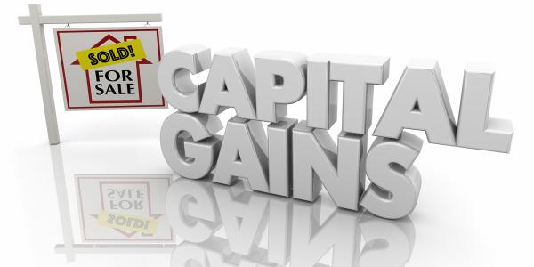 Image of the words capital gains and a for sale sign