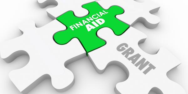 Illustration of jigsaw pieces displaying the words financial aid and grants
