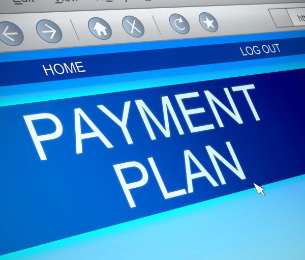 A computer screen with the words 'PAYMENT PLAN' showing against a blue background