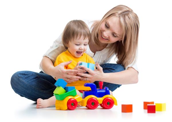 Woman with a child on her lap, playing with toys