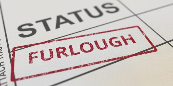 The word furlough stamped on a piece of paper